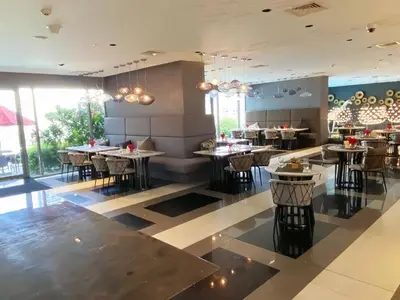 a dining room with tables and chairs in a restaurant at The hotel residences at Acqua in Manila