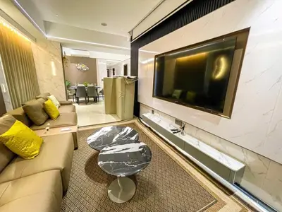a living room with a couch and a flat screen tv at Ultra Luxury 6 Bedroom beside Solaire, Okada in Manila