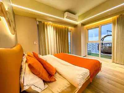 a bedroom with a bed with orange pillows and a window at Ultra Luxury 6 Bedroom beside Solaire, Okada in Manila