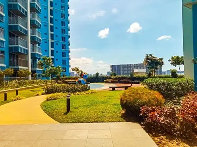 a park in front of a tall apartment building at Luxury 4 Bedroom Luxury Suite near Solaire & Okada in Manila