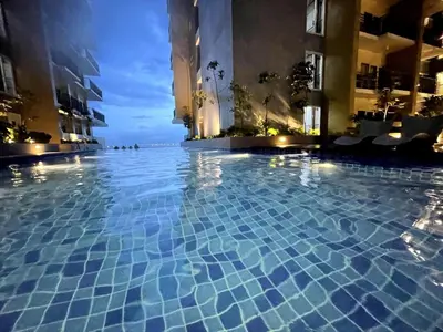 a swimming pool in the middle of a building at Elegant 2 Bedroom Suite near Solaire, Okada in Manila