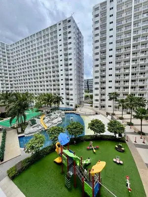 a playground in a apartment complex with buildings at Staycation near MOA, Airport in Manila
