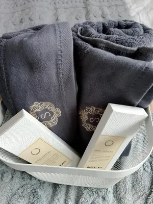 a plate with towels and two cards on a bed at Staycation near MOA, Airport in Manila