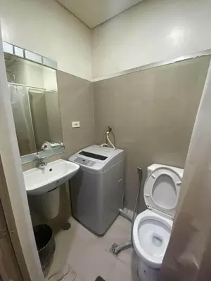 a small bathroom with a toilet and a sink at Shore Residences Tower D # 408 in Manila