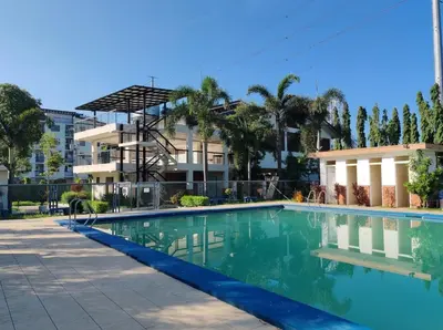 a swimming pool in front of a building at El Cozy Woody Near Enchanted Kingdom in Santa Rosa