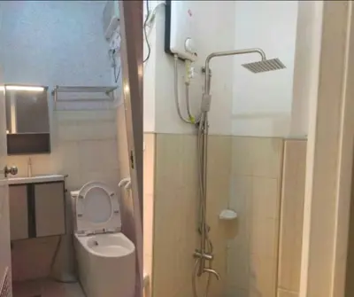 a bathroom with a toilet and a shower in it at Las Enchanted kingdom Cozy Woody in Santa Rosa
