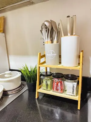 a shelf with utensils on it in a kitchen at Staycation near MOA Pasay at Shore Residences - Elizcape in Manila