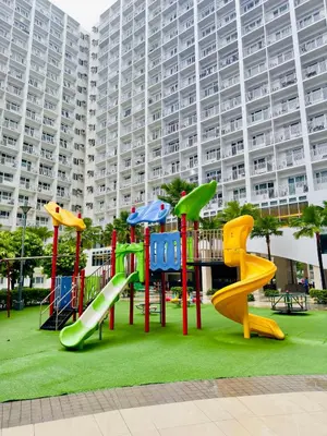 a playground in front of a large building at Staycation near MOA Pasay at Shore Residences - Elizcape in Manila
