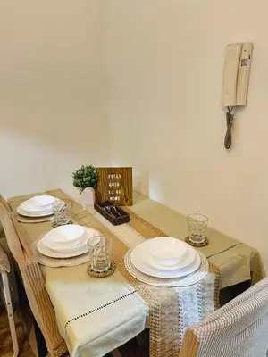 a table with plates and glasses on top of it at Staycation near MOA Pasay at Shore Residences - Elizcape in Manila