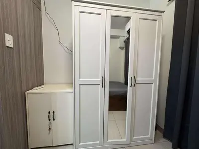 a white cabinet in a room with a bedroom at Entire 1 BR condo unit with balcony at MOA complex in Manila