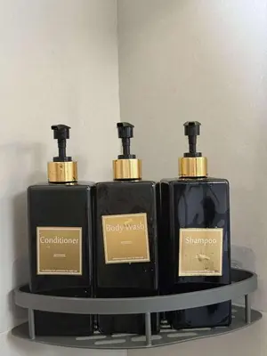 three bottles of soap sitting on a shelf at T3 Airport Condo Escape by JM and Ian in Manila