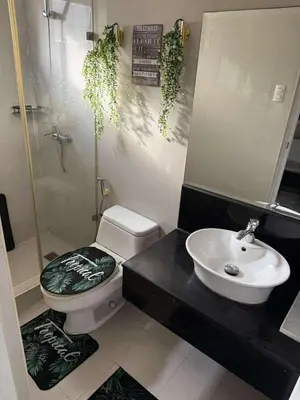 a bathroom with a toilet and a sink at T3 Airport Condo Escape by JM and Ian in Manila
