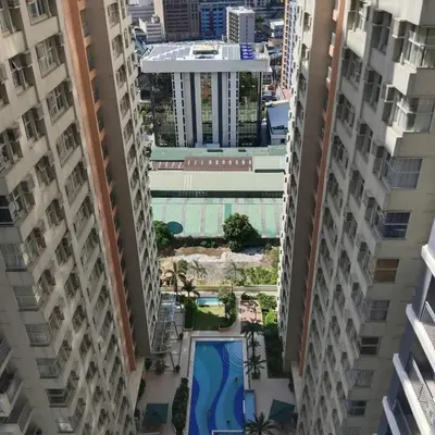 an aerial view of a building between two tall buildings at Homefort Twin Bed Suite - Red Residences Unit 2649 in Manila