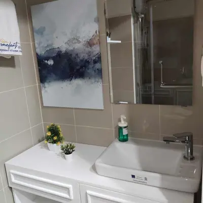 a bathroom with a sink and a mirror at Homefort Twin Bed Suite - Red Residences Unit 2649 in Manila