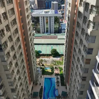 an aerial view of a building between two tall buildings at Homefort Twin Bed Suite - Red Residences Unit 2649 in Manila