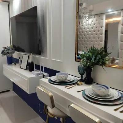 a dining room table with plates and a mirror at Homefort Twin Bed Suite - Red Residences Unit 2649 in Manila