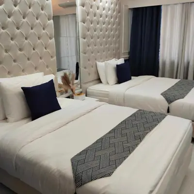 two beds in a hotel room with white sheets at Homefort Twin Bed Suite - Red Residences Unit 2649 in Manila