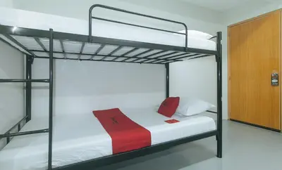a bed in a room with two bunk beds at RedDoorz at Qhouzz near PUP in Manila