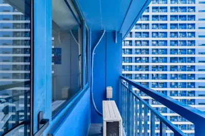 a balcony with a bench and a view of buildings at 1BR Staycation at AIR Residences Makati City in Manila