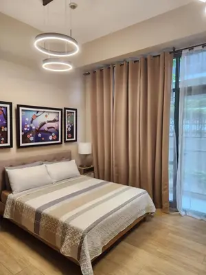 a bedroom with a bed and a large window at Staycation By JEM - Across NAIA T3 in Newport City in Manila