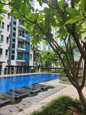 a swimming pool in front of a building at Staycation By JEM - Across NAIA T3 in Newport City in Manila