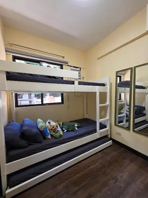 a bunk bed room with two bunk beds and a mirror at The Yanoa Stay 2 Bedroom Condo in Manila