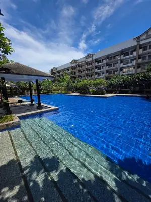 a large swimming pool in front of a building at The Yanoa Stay 2 Bedroom Condo in Manila