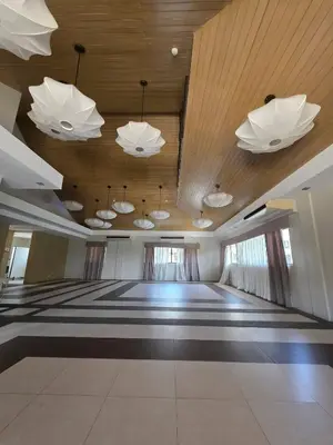 a conference room with white lights and a wooden ceiling at The Yanoa Stay 2 Bedroom Condo in Manila