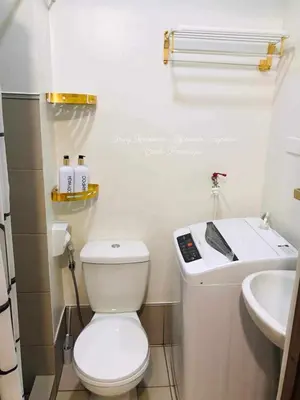a small bathroom with a toilet and a sink at Sky Suites at Spring Residences Condotel near NAIA and SM Bicutan Mall in Manila
