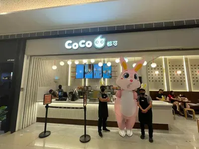 two people standing in front of a store with a giant pink donkey at Air Residences- Netflix with City View in Manila
