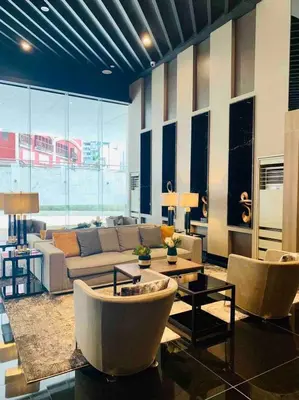 a living room with a couch and a table at Air Residences- Netflix with City View in Manila