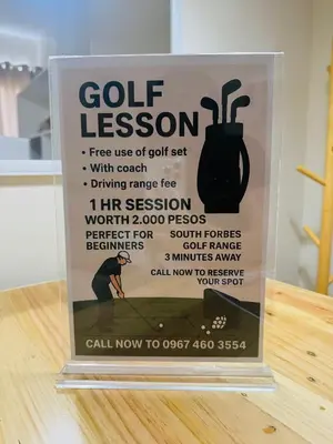 a sign for a golf lesson on a table at Berkeley Breeze Staycation in Silang