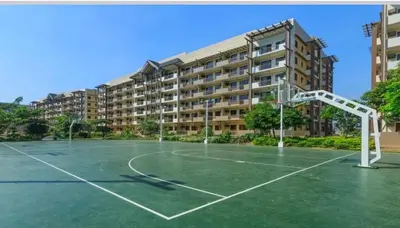 an empty basketball court in front of a building at Arista Place 2 bedroom Condo near airport in Manila