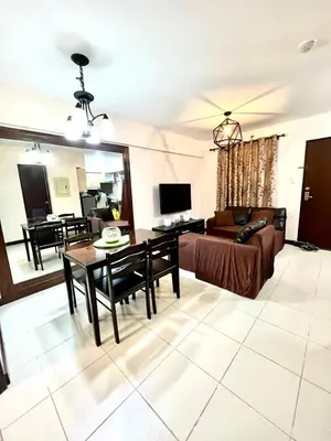 a living room with a couch and a table at Arista Place 2 bedroom Condo near airport in Manila
