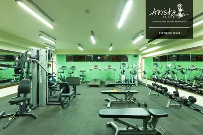 a gym with a lot of treadmills and machines at Arista Place 2 bedroom Condo near airport in Manila