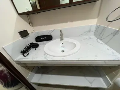 a white counter top with a sink in a bathroom at Arista Place 2 bedroom Condo near airport in Manila
