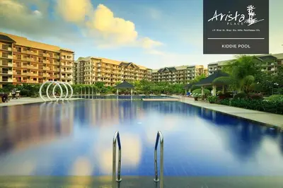 a large swimming pool in front of some buildings at Arista Place 2 bedroom Condo near airport in Manila