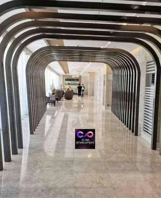 a lobby with a sign in the middle of a building at Mall of Asia gateways shore 3 condotel in Manila