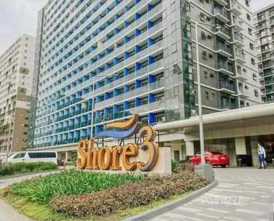 a sign in front of a large building at Mall of Asia gateways shore 3 condotel in Manila