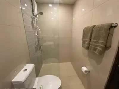 a bathroom with a shower and a toilet and a sink at 2-min Walk to Okada Near AirportMOA wBalcony in Manila