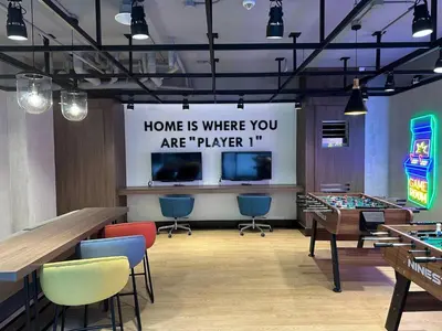 a game room with tables and chairs and a sign at 2-min Walk to Okada Near AirportMOA wBalcony in Manila