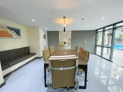 a dining room with a table and chairs and a couch at 2-min Walk to Okada Near AirportMOA wBalcony in Manila