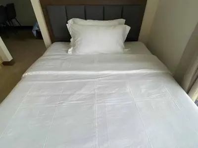 a white bed with a pillow in a room at Airport Home Base Trips Getaways 3pax balcony 6g in Manila