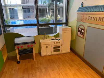 a play room with a pretend kitchen and a toy stove at Airport Home Base Trips Getaways 3pax balcony 6g in Manila