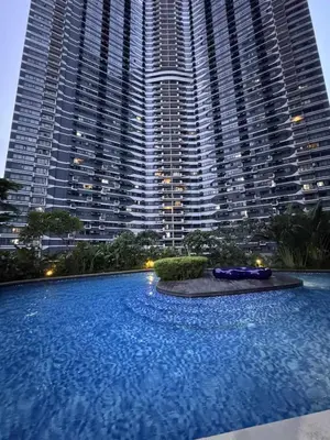 a large swimming pool in front of a tall building at Fully-furnished 1-br unit in Manila