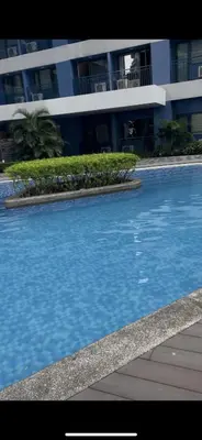 a large swimming pool in front of a building at Fully-furnished 1-br unit in Manila
