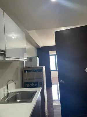 a kitchen with a sink and a blue wall at Fully-furnished 1-br unit in Manila