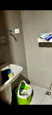a bathroom with a sink and a trash can at Fully-furnished 1-br unit in Manila