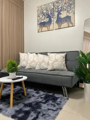 a living room with a couch and a table at The Ren Suite Facing Amenities in Manila