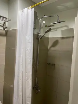 a shower in a bathroom with a shower curtain at The Ren Suite Facing Amenities in Manila